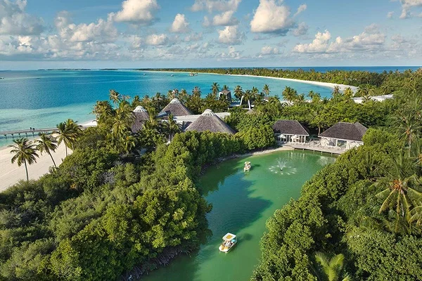 Family-friendly Maldives resort beach with calm shallow lagoon